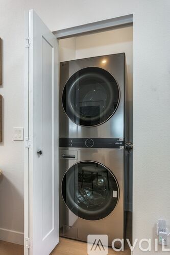 A modern stainless steel oven and microwave are installed in a kitchen.