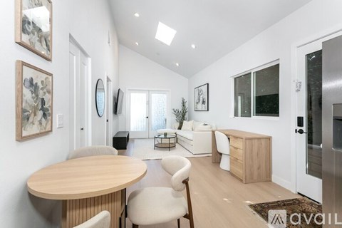 A modern living room with a wooden table and chairs.