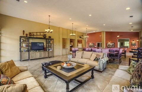 A living room with a brown couch and a coffee table.