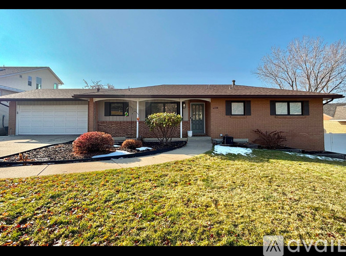 A house with a brown roof and a white garage door.
