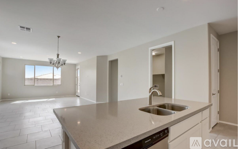 A kitchen with a sink and a window.