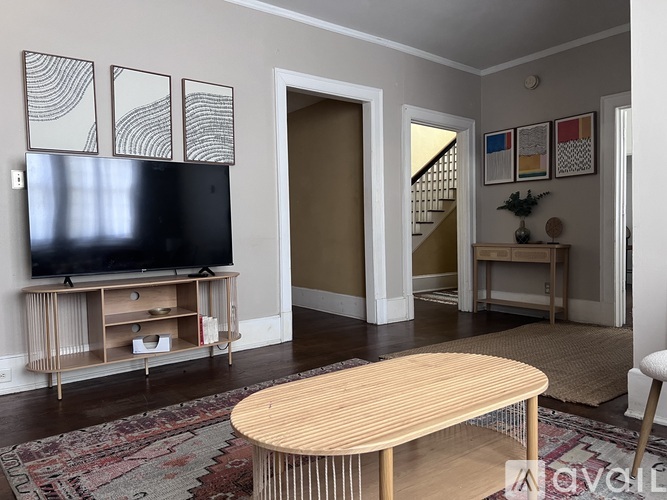 A living room with a wooden table and a television.