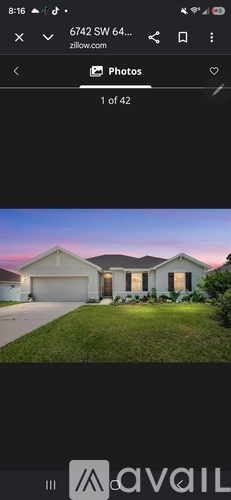 A house with a well-maintained lawn is shown.