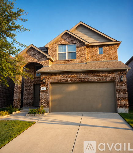 A house with a garage and a driveway in front.