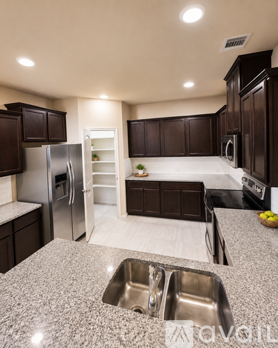 A kitchen with granite countertops and stainless steel appliances.
