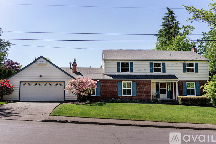 A house with a blue door and a white garage door.