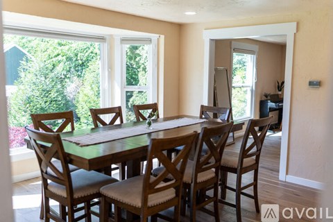 A dining room with a table and chairs.