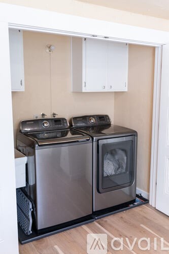 A modern kitchen with two ovens and a microwave.