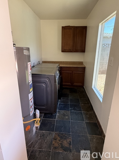 A kitchen with a fridge and a window.