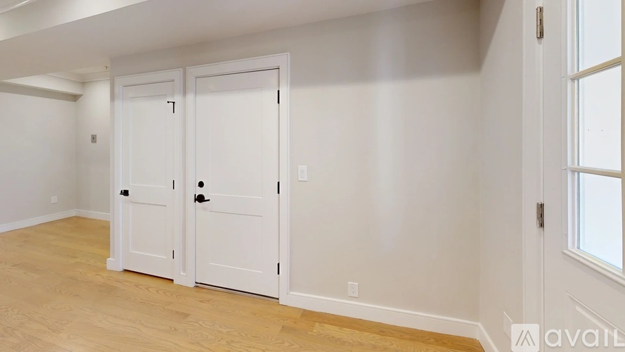 A room with two doors and a window.