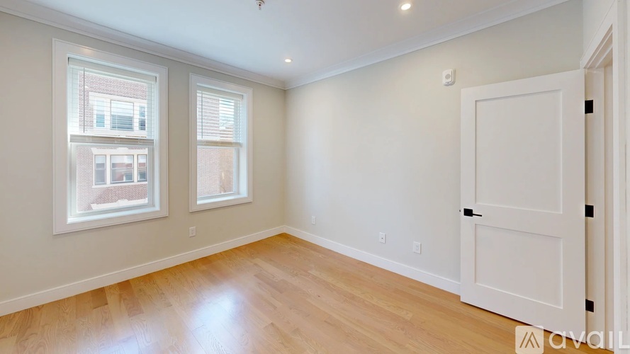 A room with a wooden floor and a white door.