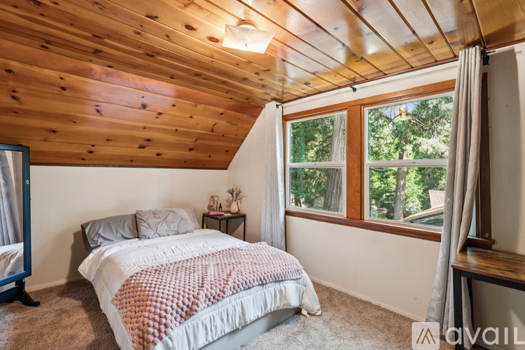 A bedroom with a bed and a window.