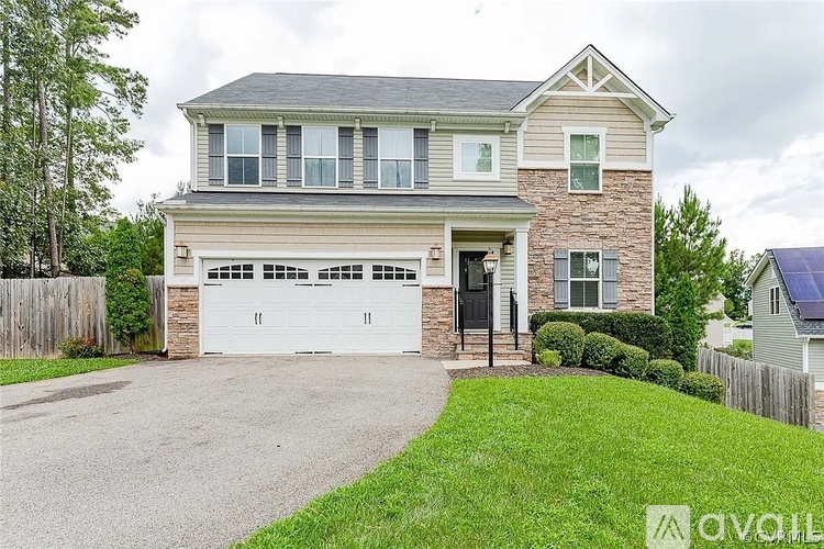 A two-story house with a garage is available for sale.