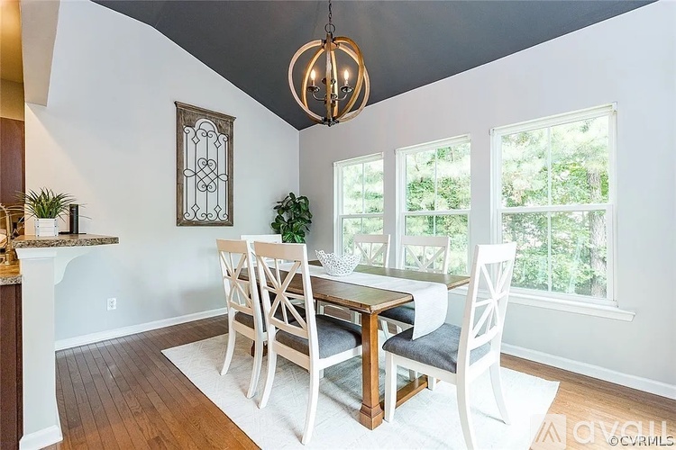 A dining room with a table set for four.