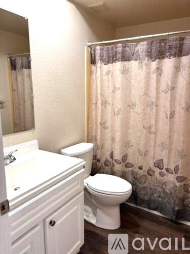 A white toilet sits next to a sink in a bathroom.