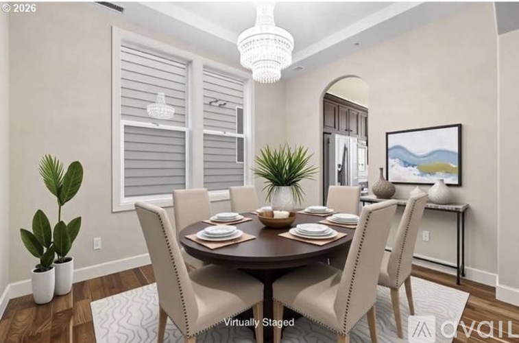 A dining room with a round table set for six.