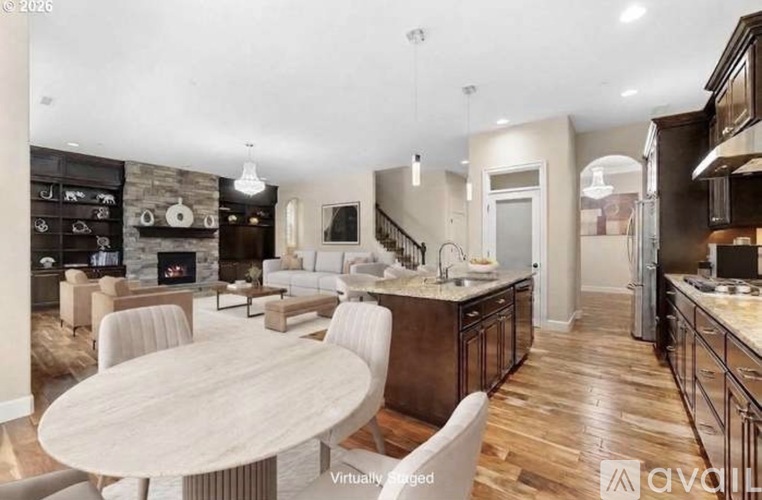 A modern kitchen with a dining table and chairs.