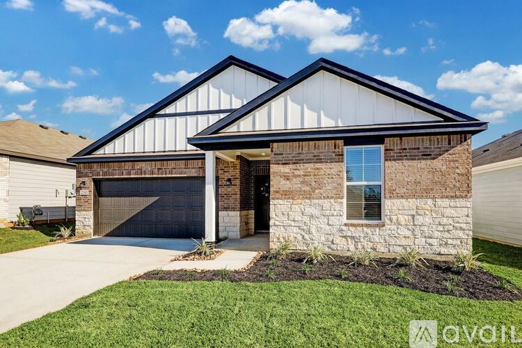 A house with a garage and a driveway in front.