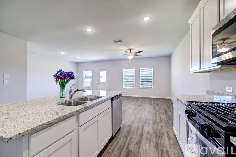 A kitchen with granite countertops and stainless steel appliances.