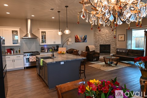 A kitchen with a large island and a chandelier hanging from the ceiling.