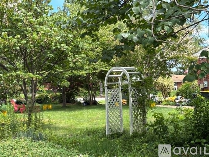 A metal gate is in the middle of a grassy area.