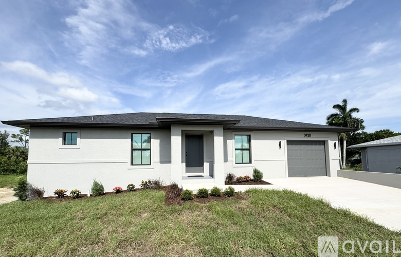 A modern house with a white exterior and a grey roof is for sale.
