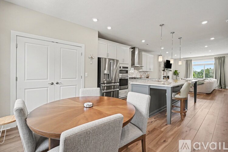 A modern kitchen with a dining table and chairs.