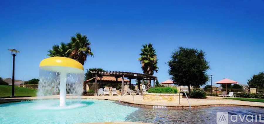 A pool with a yellow and white waterfall in the middle of it.