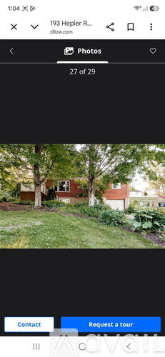 A photo album on a phone screen showing a house with a garden.