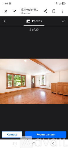 A room with wooden floors and a large window.