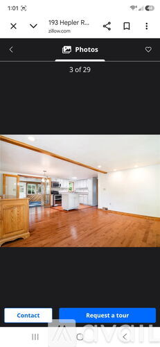 A room with wooden flooring and white walls.