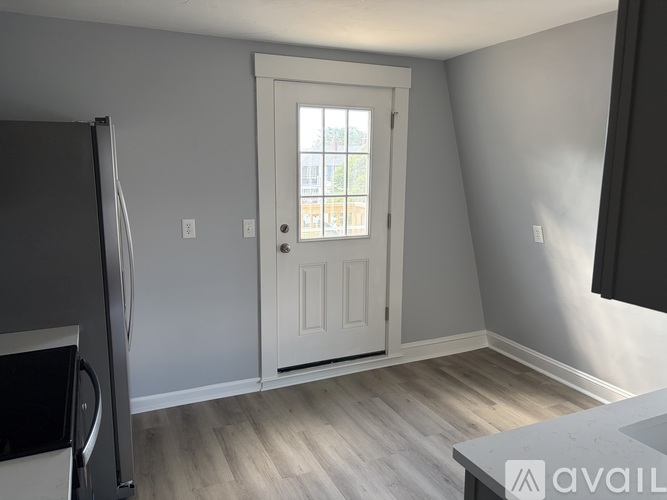 A room with a white door and a window.