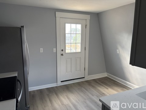 A room with a white door and a window.