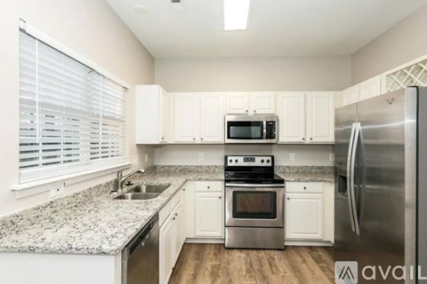 A kitchen with granite countertops and stainless steel appliances.