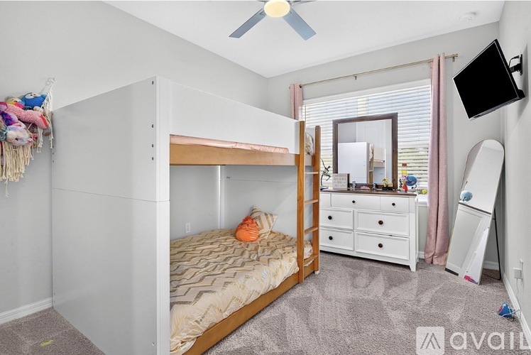 A bedroom with a bunk bed and a dresser.