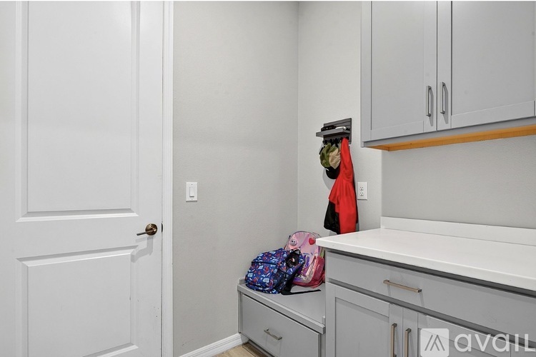A kitchen with a white door and cabinets.