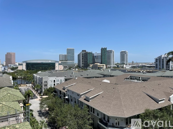 A view of a cityscape with buildings and a clear blue sky.