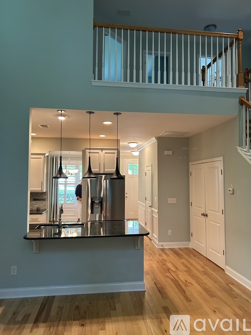 A kitchen with a counter and a stainless steel refrigerator.