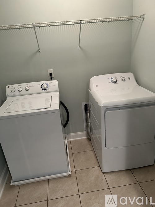 A white washing machine and dryer in a small laundry room.