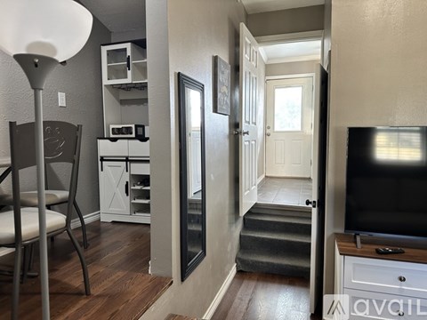 A living room with a television and a chair.