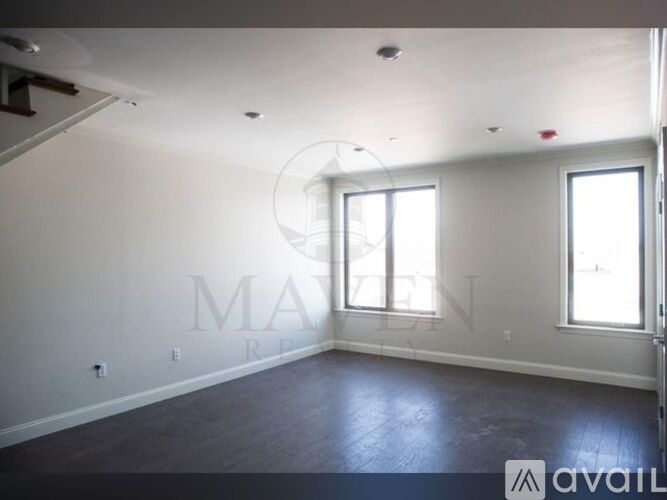 A spacious room with a window and a door.