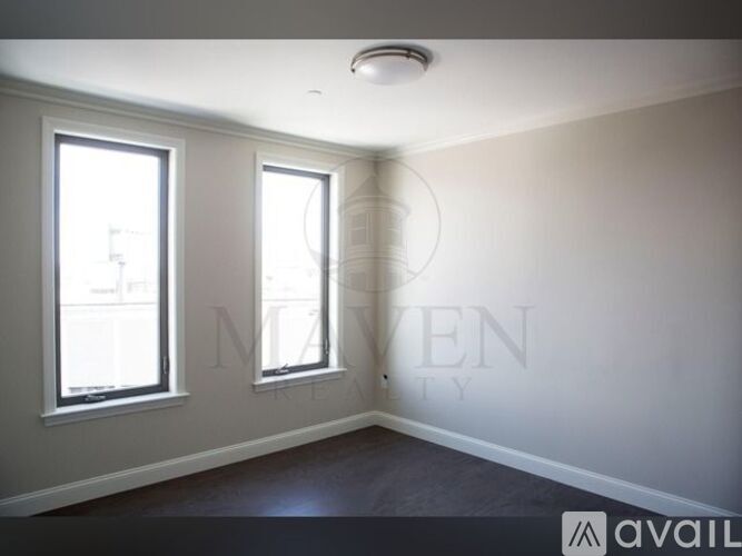 A room with two windows and a textured wall.