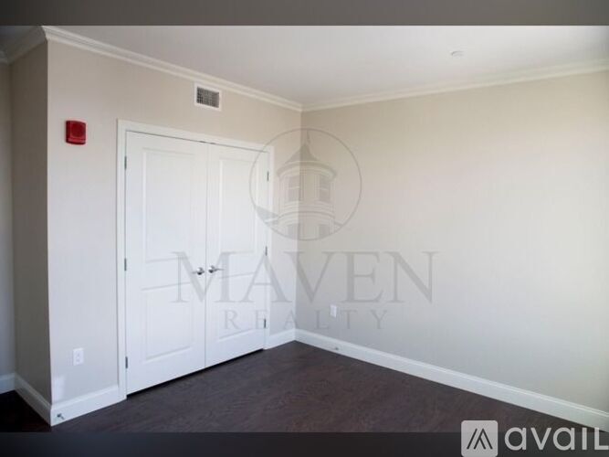 A room with a door and a wall with a logo on it.
