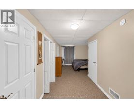 A bedroom with a bed, dresser, and closet.