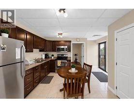 A kitchen with brown cabinets and a refrigerator.
