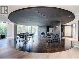 A modern dining room with a large table and chairs.