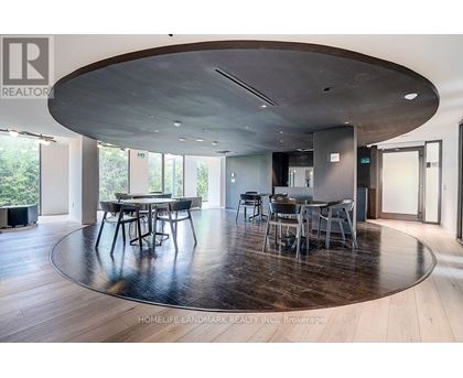 A modern dining room with a large table and chairs.