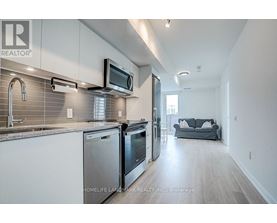 A modern kitchen with stainless steel appliances and a microwave mounted above the oven.