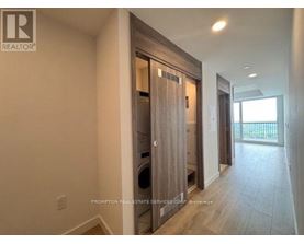 A hallway with a washer and dryer in a home.