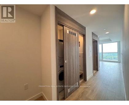 A hallway with a washer and dryer in a home.
